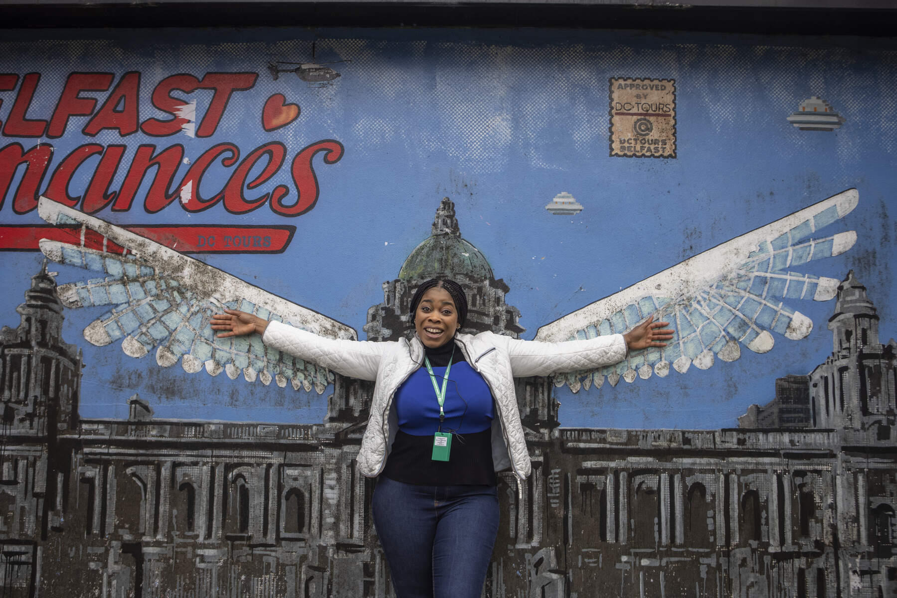 Woman posing in front of mural in Belfast